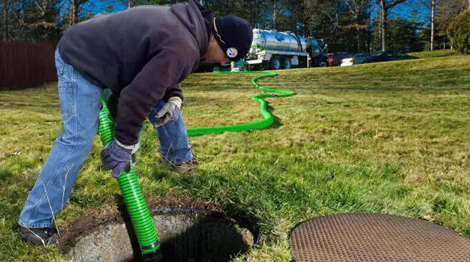 Service technician performing residential septic pumping and drainage maintenance in Marietta, GA